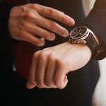 Closeup businessman looks at his watch